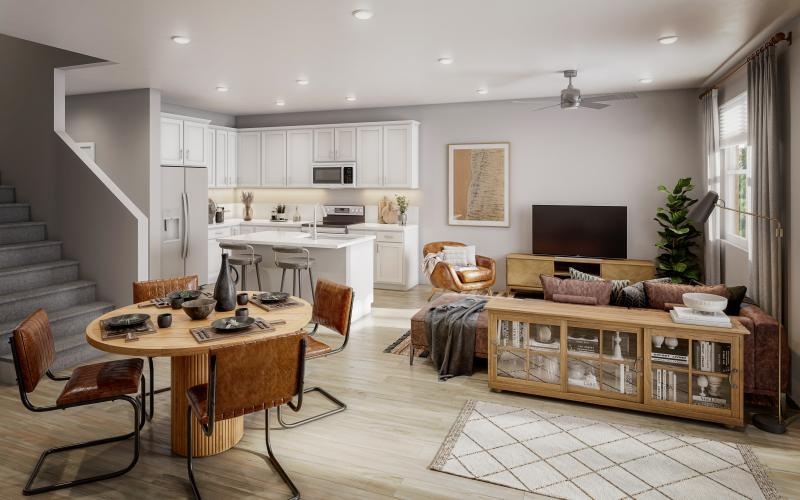 a kitchen and living room, couch, table and chairs